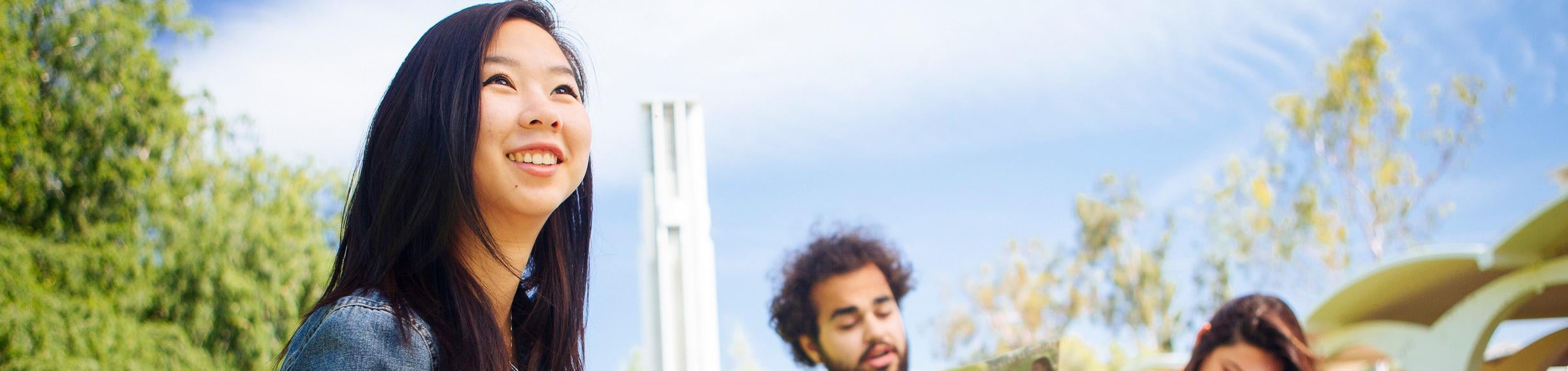 Business Students on University lawn in front of Bell Tower