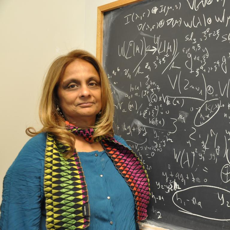 Math professor at chalkboard 