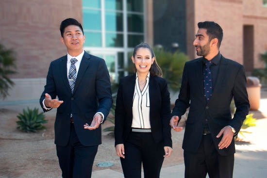 Three Business Students in Suits Walking Campus