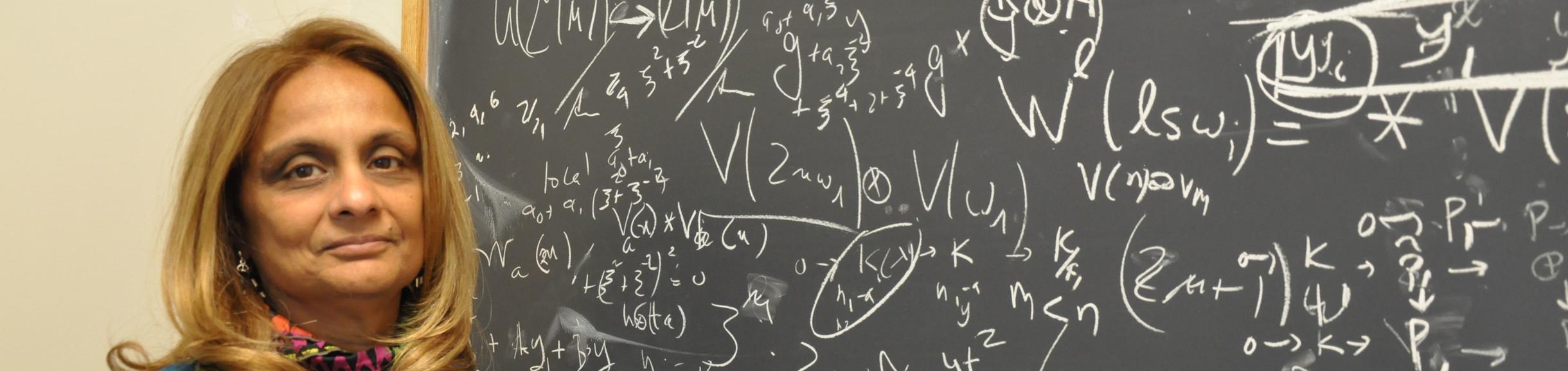 Math professor at chalkboard